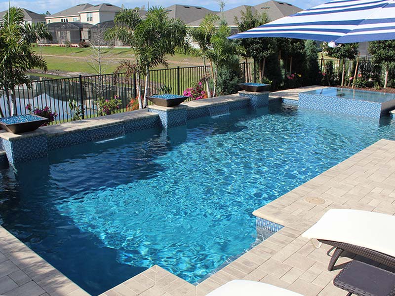Backyard pool with fountain features and spa